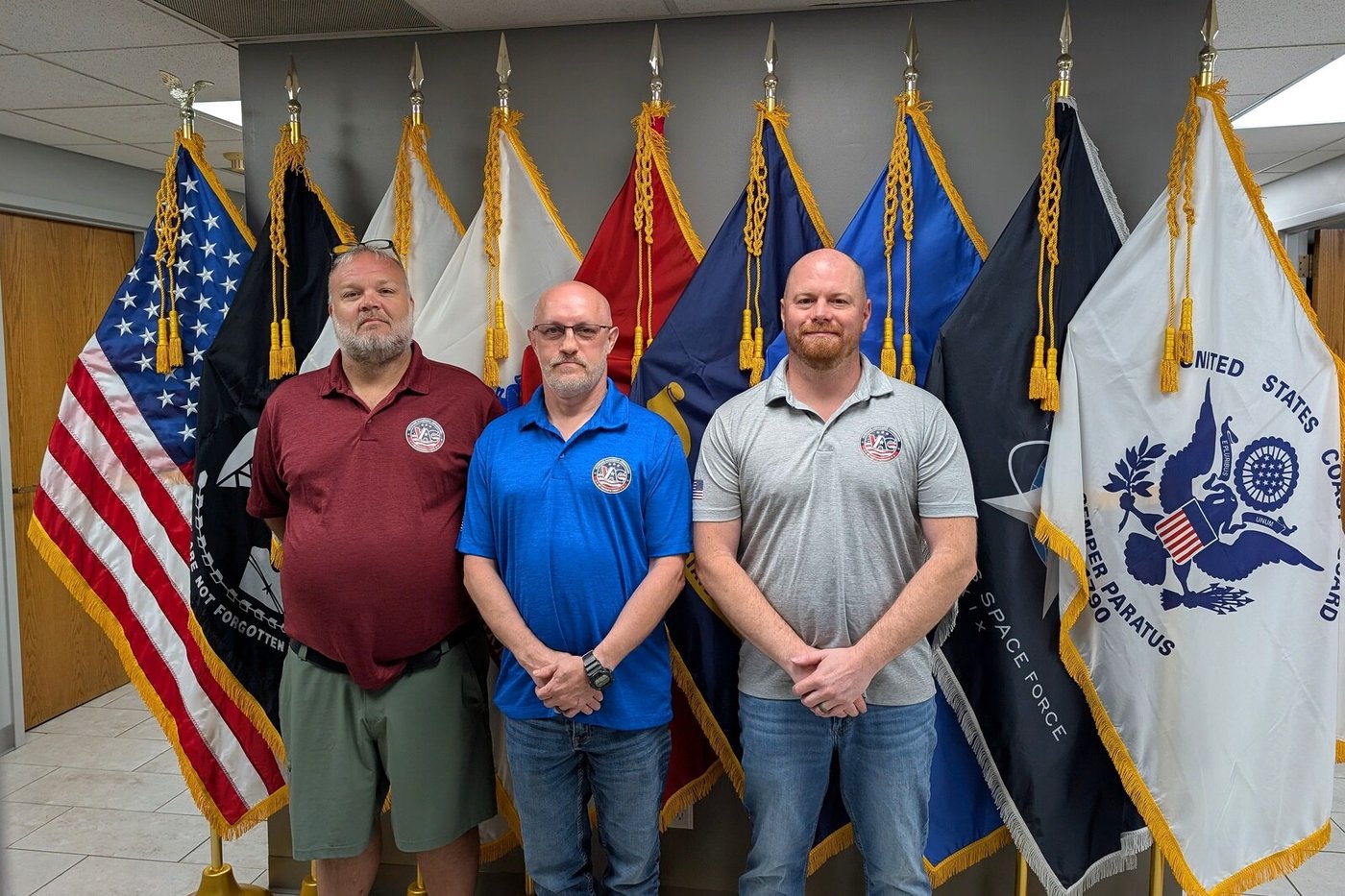 The Macoupin County VAC team &mdash; accredited Veterans Service Officers standing in front of the U.S. and military service flags